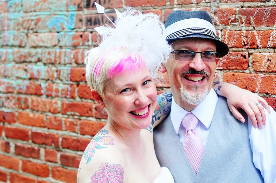 offbeat couple in brick alleyway