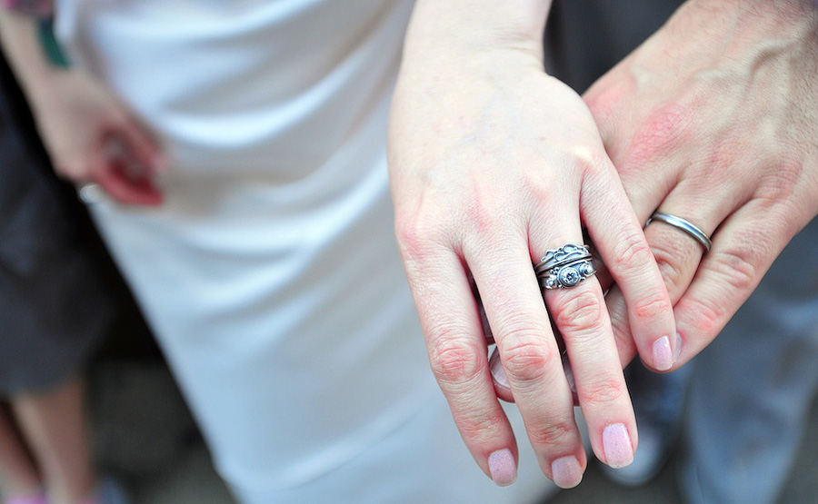 couple showing off wedding rings