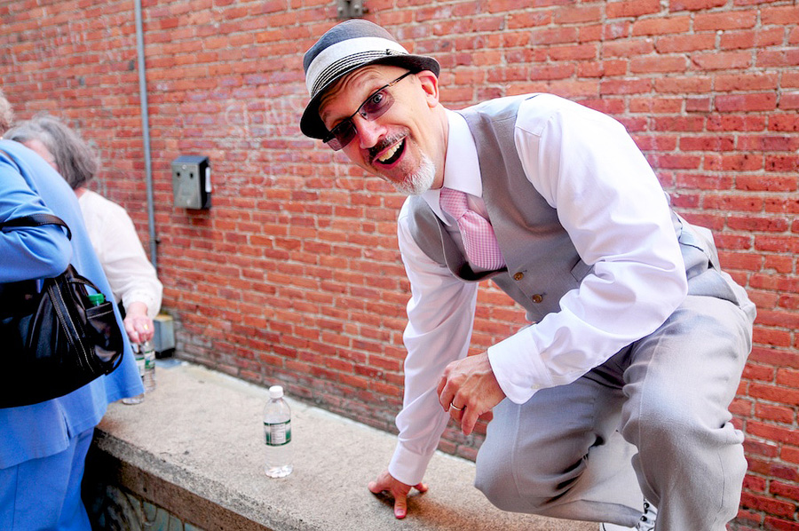 groom in pink tie and fedora