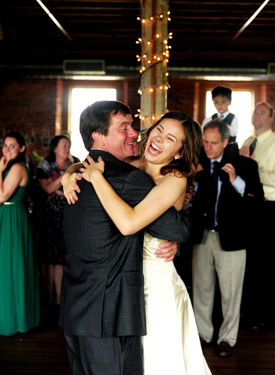 Sarah laughing as she dances with her dad.