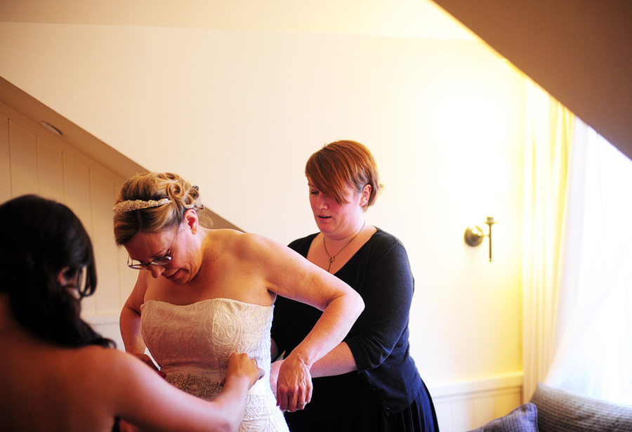 Tina expanding her talents to help tie Elizabeth's dress sash!