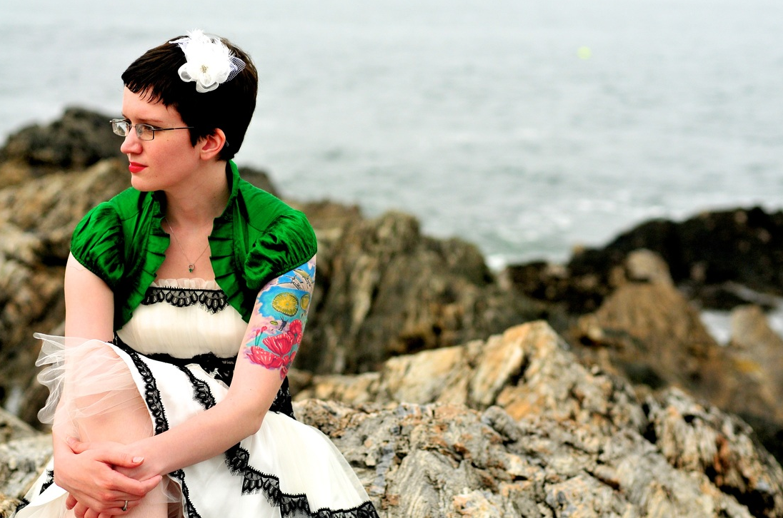 Caitlin wore a shorter white dress with black accents, cute pops of tulle, an emerald green bolero, and wore her Converse (not pictured). :)