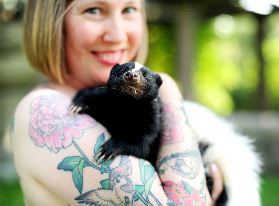 bride holding a baby skunk