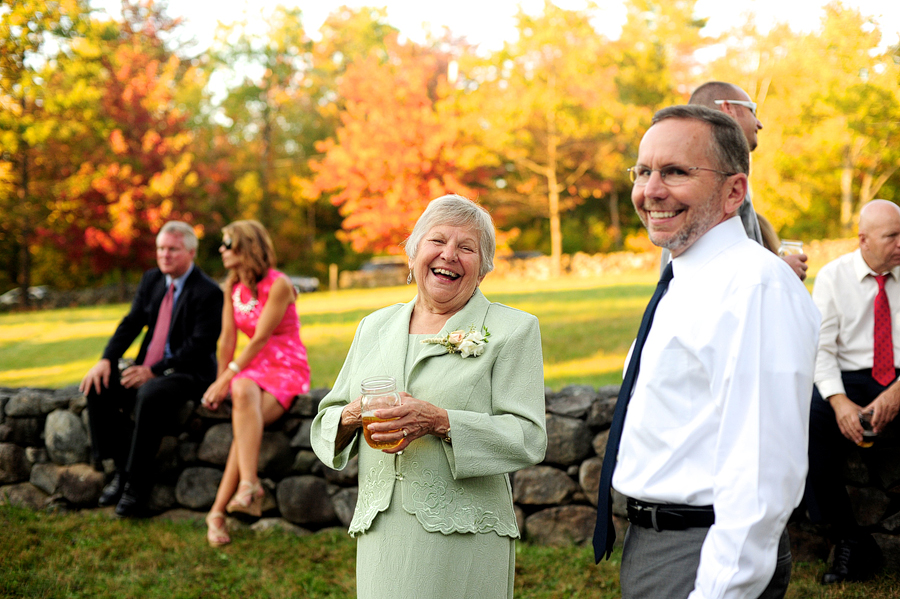 guests laughing at cocktail hour at new hampshire wedding
