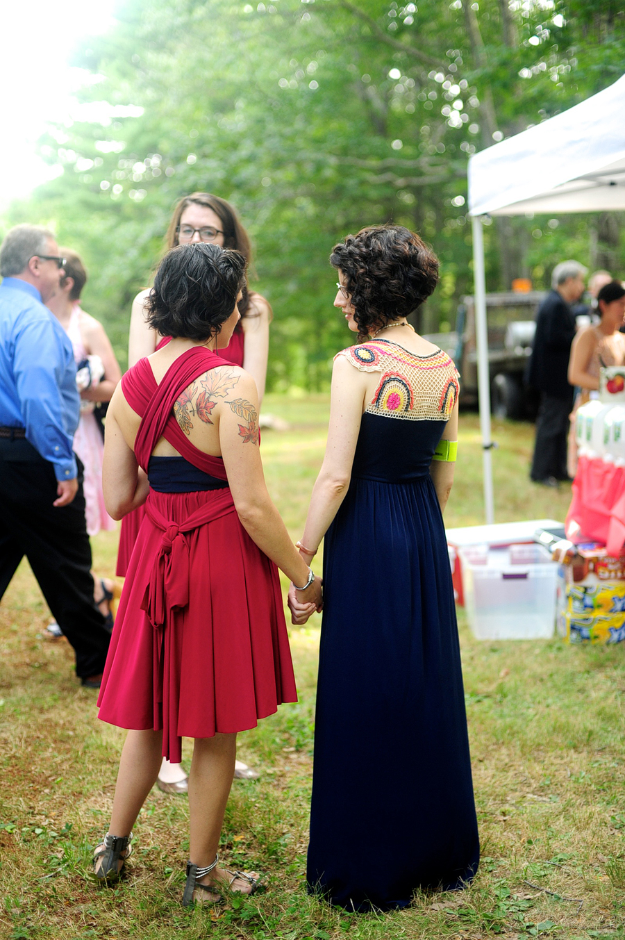 bride in a blue dress holding hands with her sister