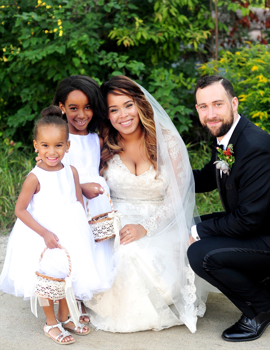 couple with their flower girls at their maine wedding