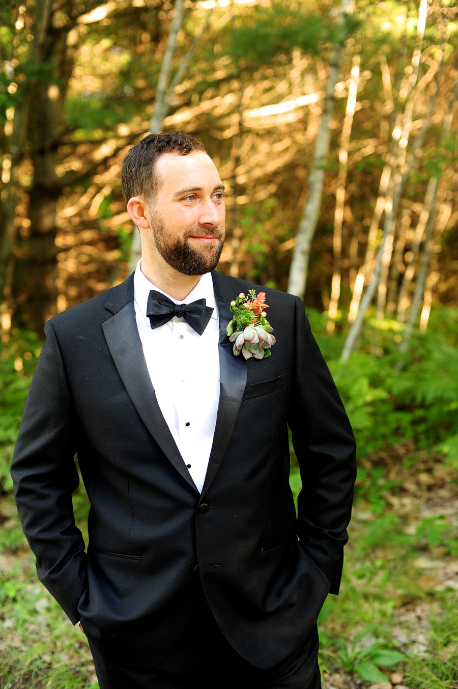 groom in a black tux with a succulent boutonniere