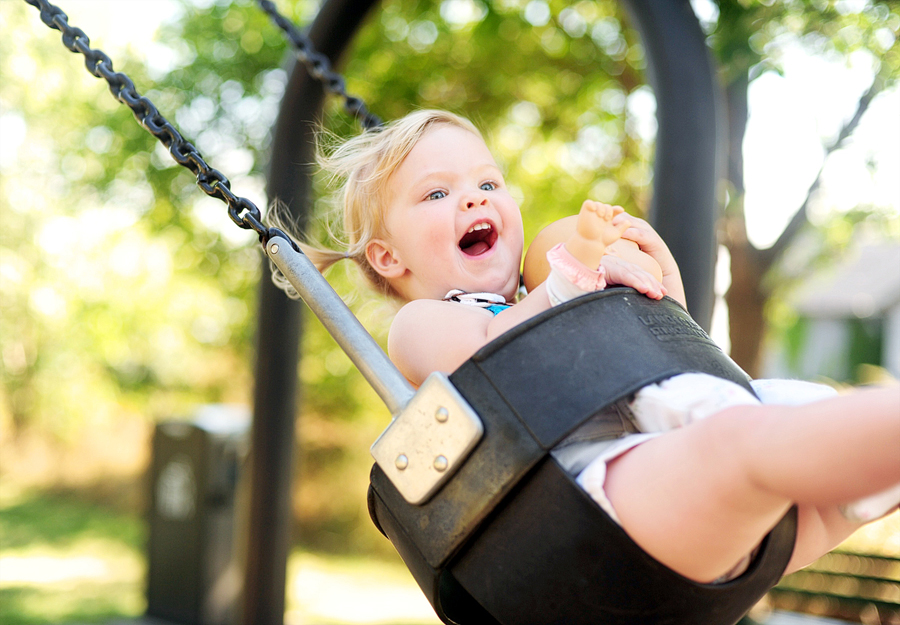 little girl on the swings at castle island