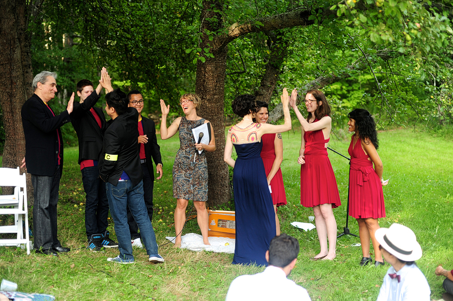 couple high fiving their wedding party
