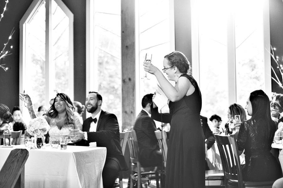 candid black and white wedding toast in maine
