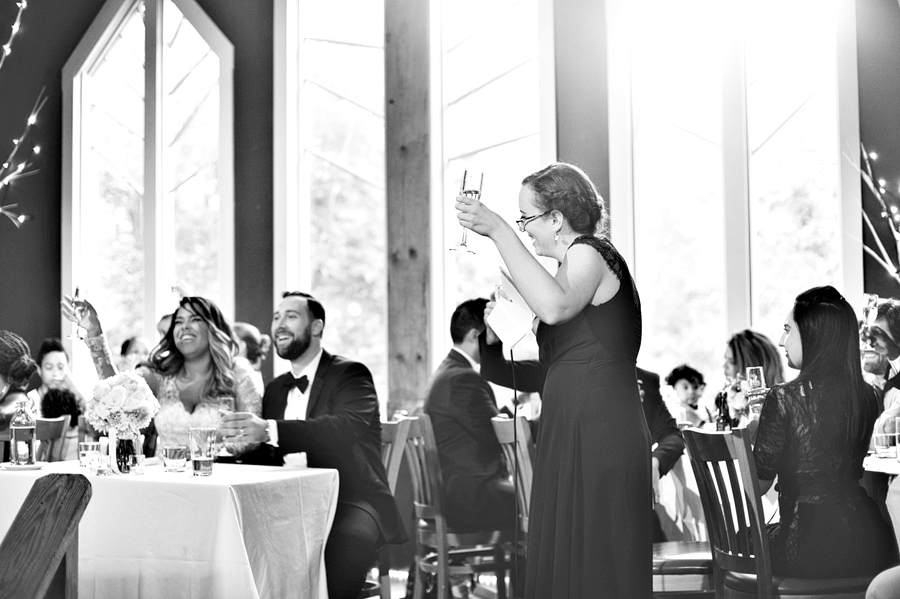 candid black and white wedding toast in maine