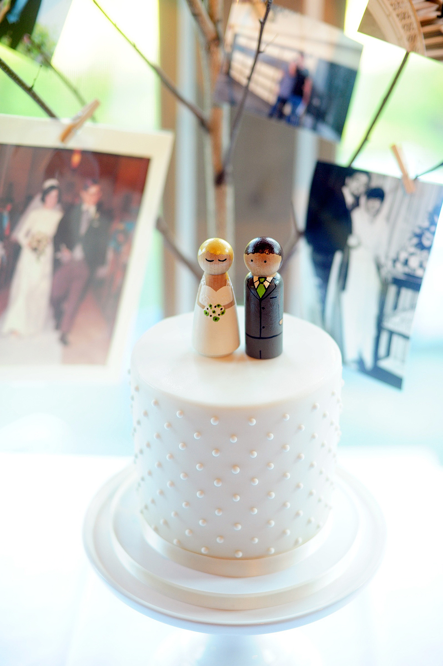 cute, small wedding cake with hand painted wooden cake toppers