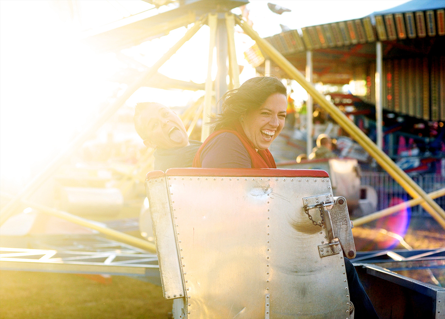 couple laughing on a carnival ride