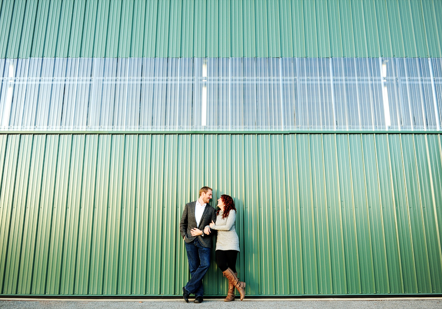 couple against a green wall