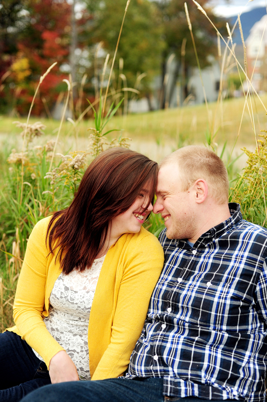 couple cuddling in the grass at sugarloaf mountain