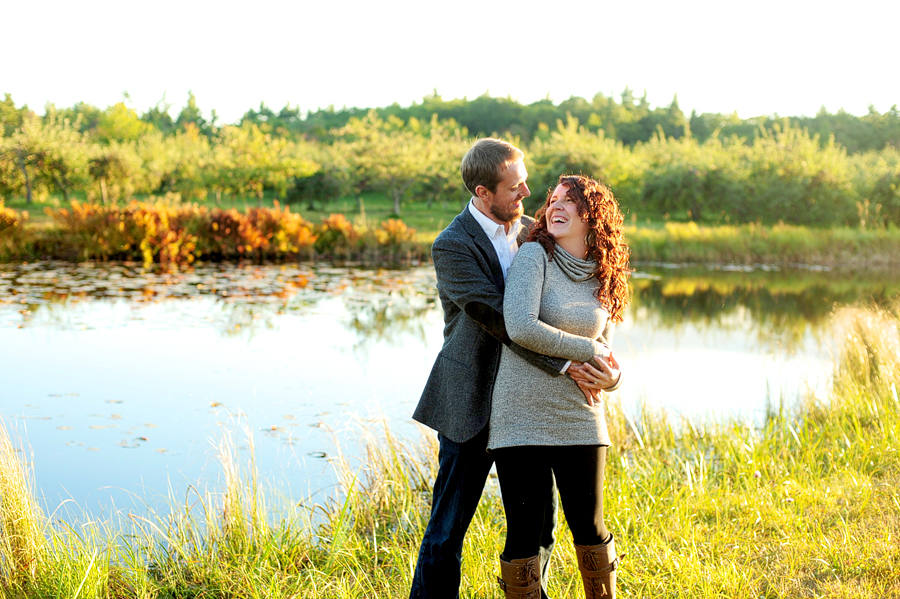 couple laughing by a pond