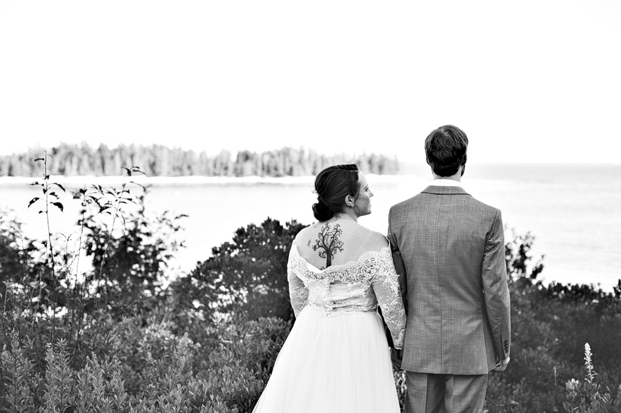 black and white photo of a bride with a back tattoo