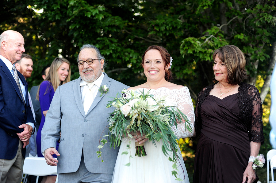 bride walking down the aisle with her parents