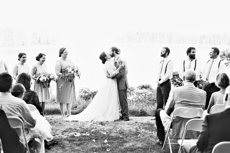 black and white photo of a wedding first kiss
