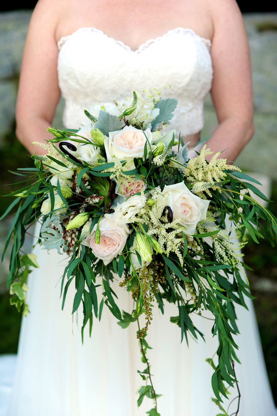 bride holding a unique, draped bouquet