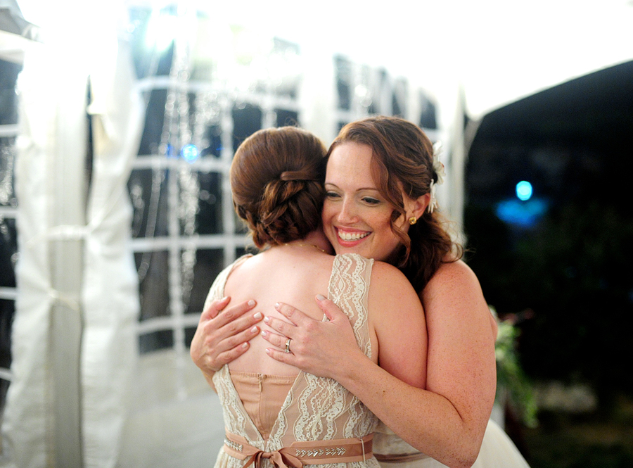 a bride hugging her sister