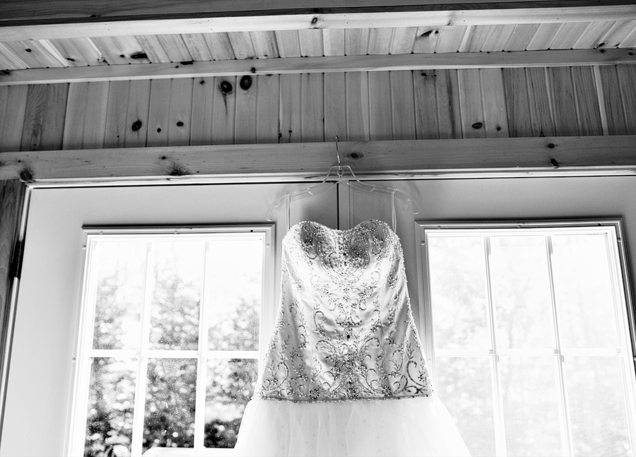 wedding dress hanging in rustic home
