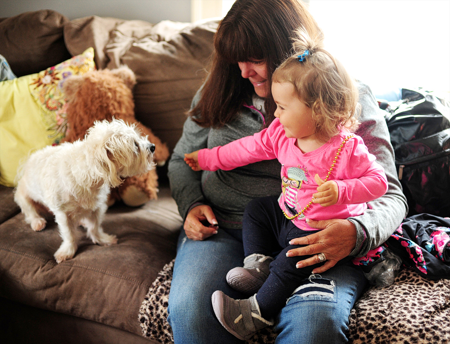 young girl playing with dog