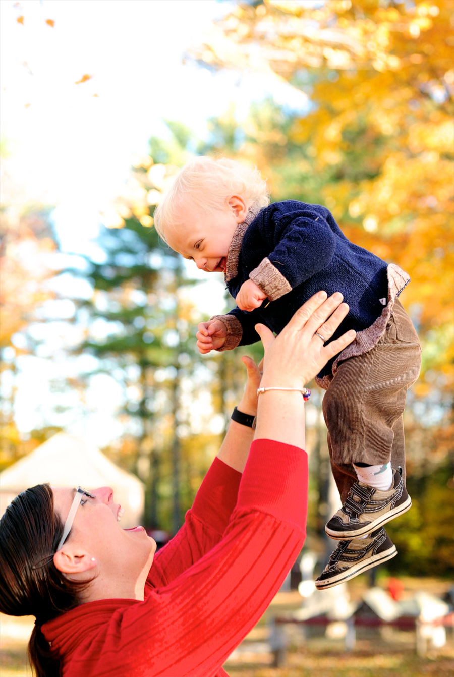 mother tossing baby in the air