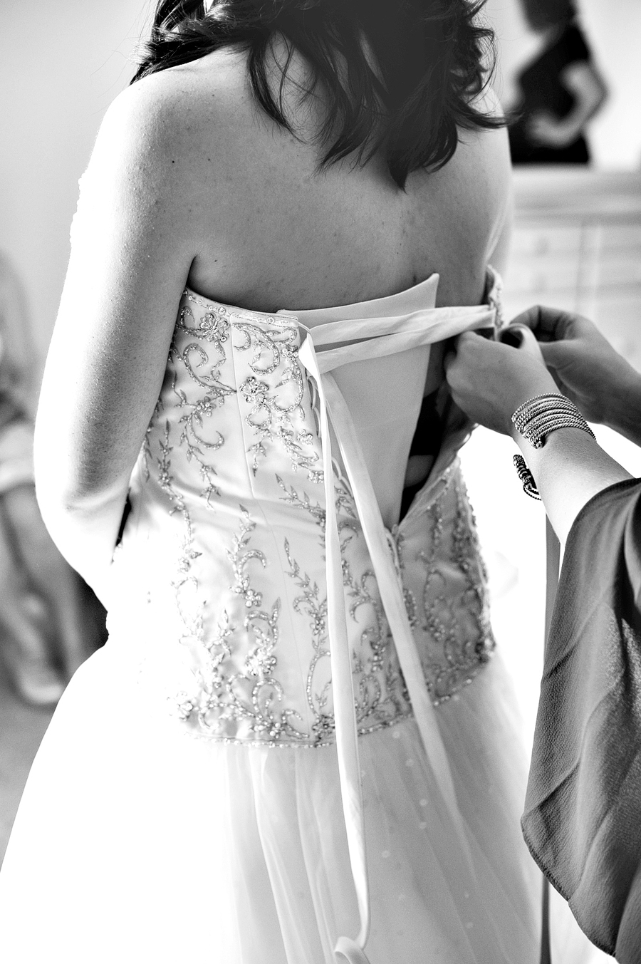 bride getting into her wedding dress