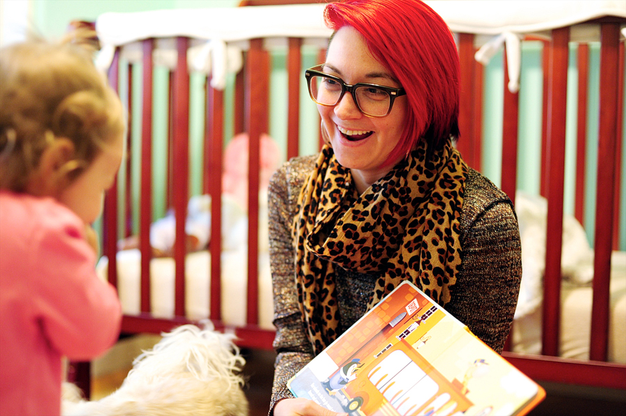 woman with red hair reading to her daughter