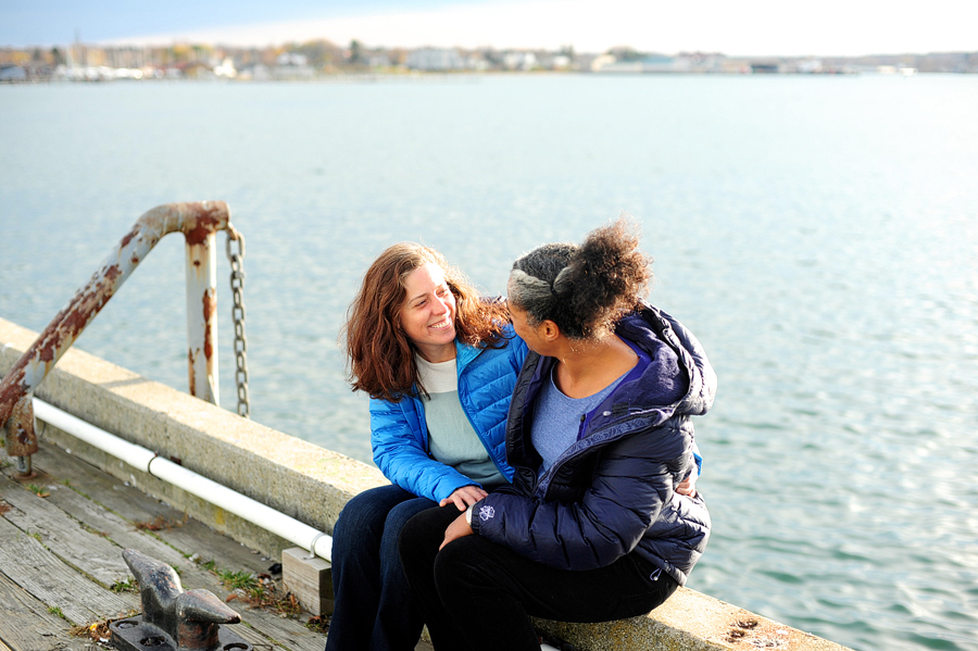 couple cuddling by the ocean