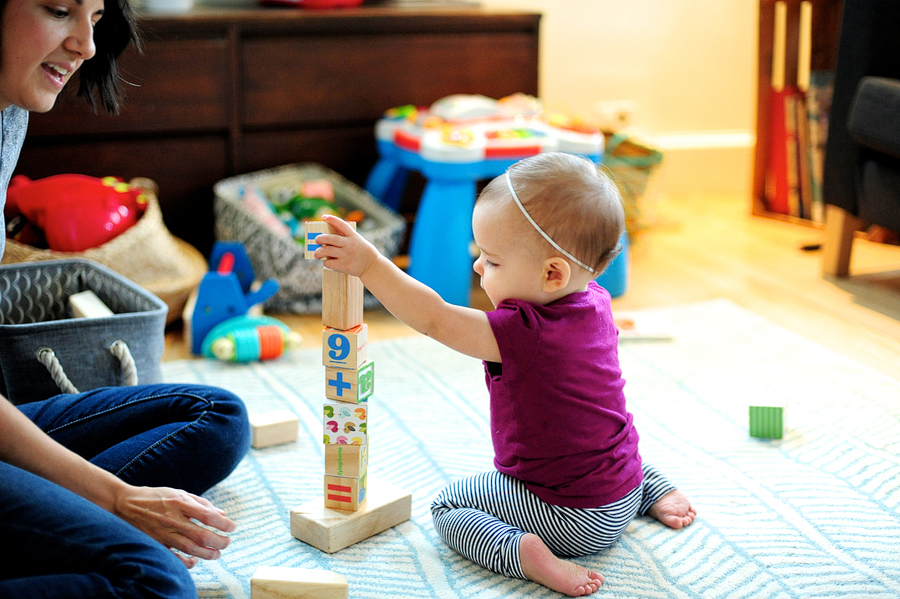 baby girl making block tower