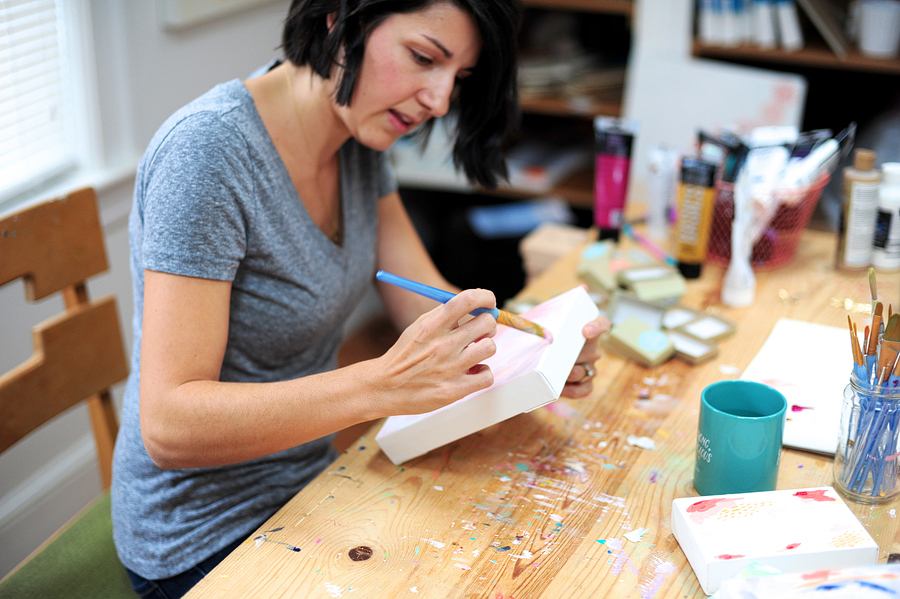 an artist painting a canvas