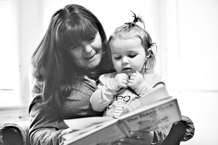 woman reading to her granddaughter