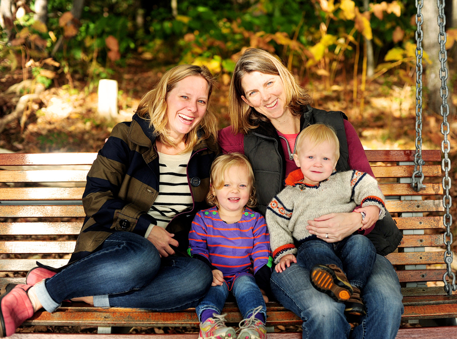 family sitting on swing on mackworth island