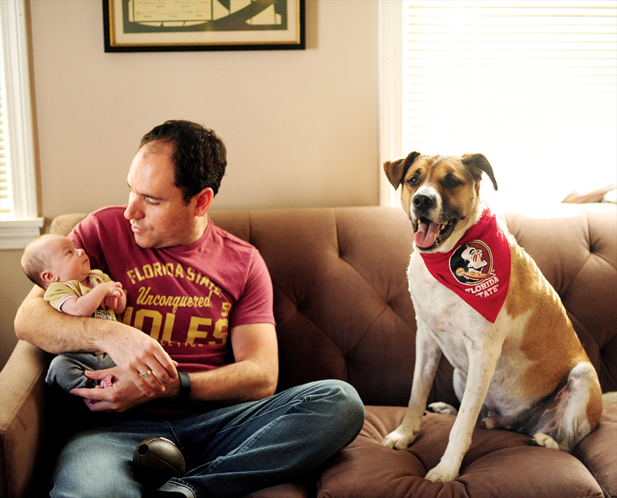 dad with his newborn son and dog