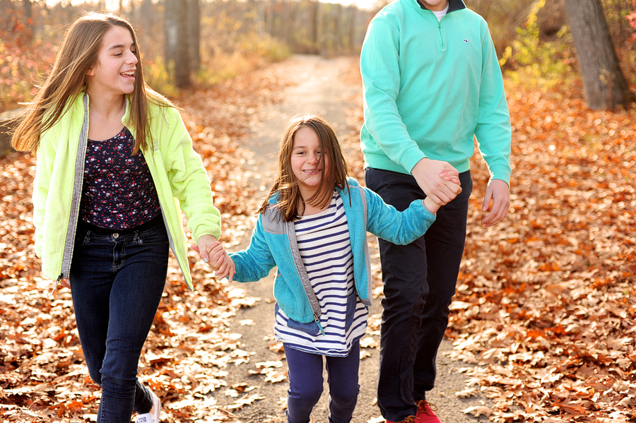 siblings walking in maine foliage