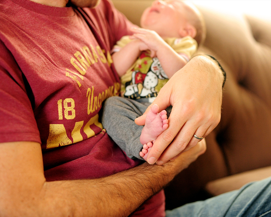 dad holding his son's feet