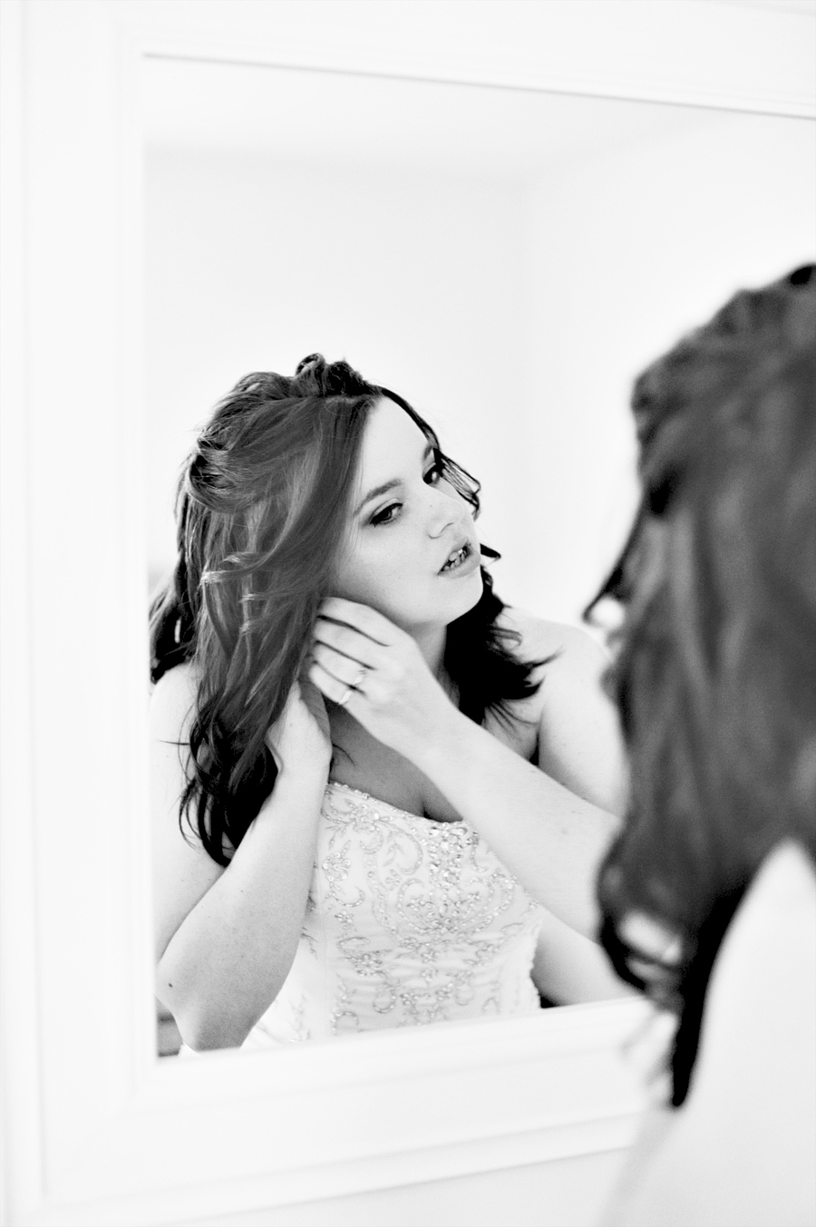 black and white photo of a bride getting ready