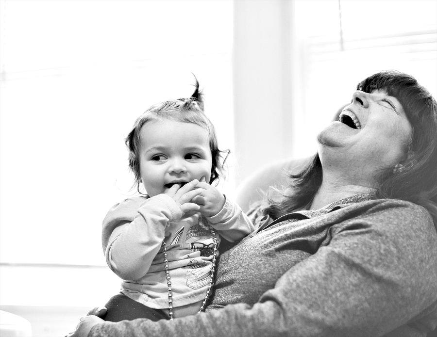 woman laughing with her granddaughter