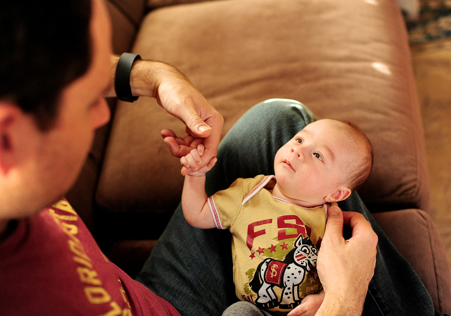 dad holding baby's hand