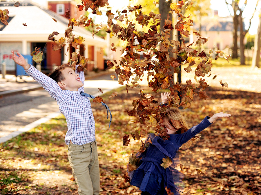 kids playing in the leaves in prescott park