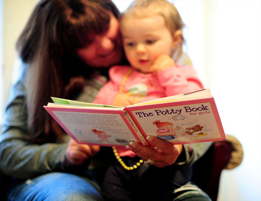 little girl reading the potty book for girls