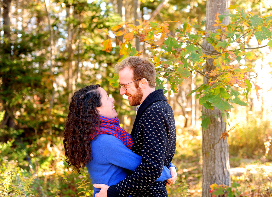 couple cuddling in the woods