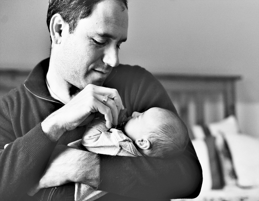 dad putting pacifier in baby's mouth