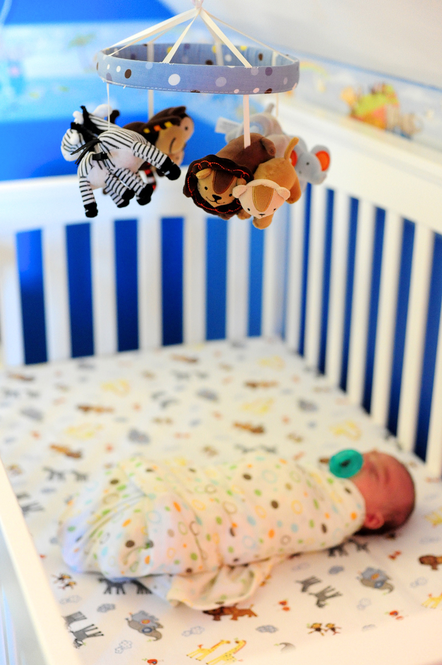 baby swaddled in crib