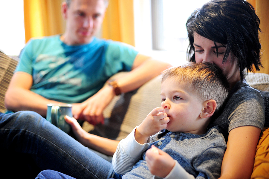 couple cuddled with their son