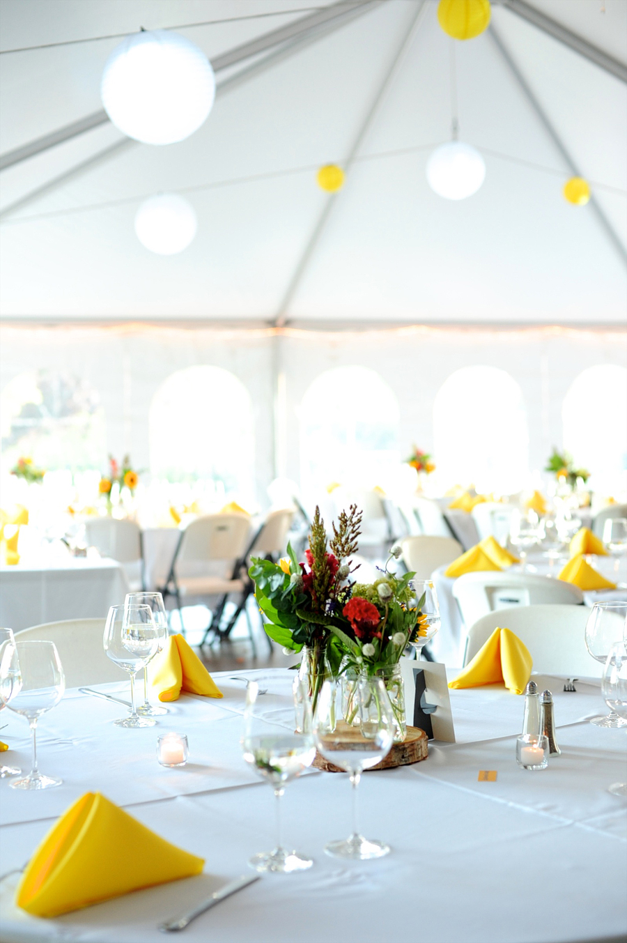 yellow and white reception decor with paper lanterns