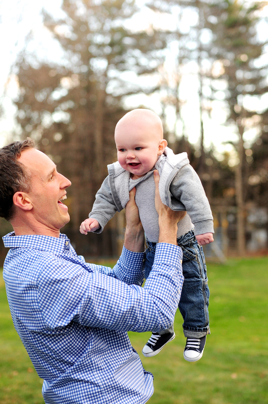 father lifting son in air