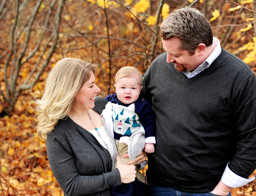 family in fall leaves